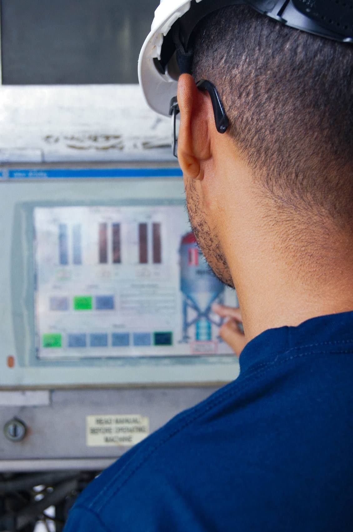 Operator acting on information at a plant control panel